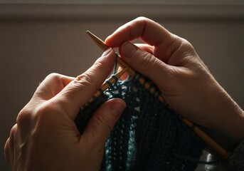 Knitting hands in warm light, handmade craft and cozy creative hobby