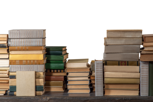 Stacks of many books on a shelf or table on an isolated background. Concept of library, reading, old classic literature
