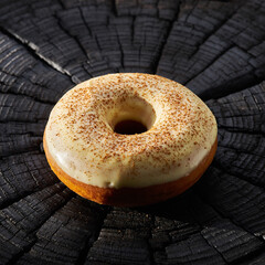 Obraz premium Vibrant Green Glazed Donut on Black Textured Surface with Shadow