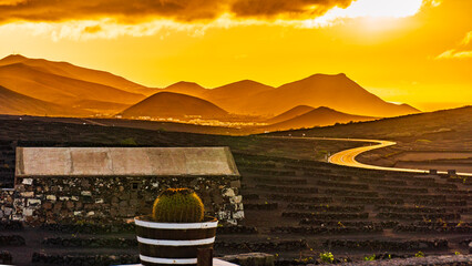 Golden Light on Volcanic Hills and Road
