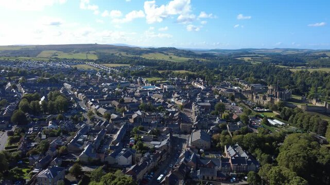 Scenic high aerial view of the town of Alnwick in Northumberland showing the town streets and buildings surrounded by countryside