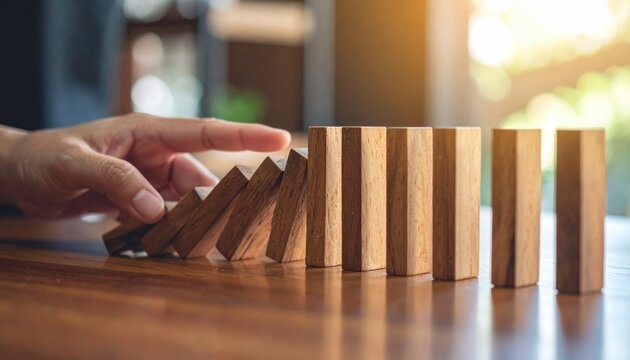 Person arranging blocks on table individual meticulously positions various blocks on flat surface demonstrating careful arrangement