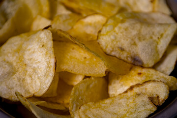 Crispy potato chips served in a bowl, perfect for snacking during parties or movie nights at home