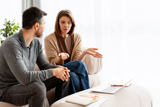 Couple having therapy session discussing problems with counselor