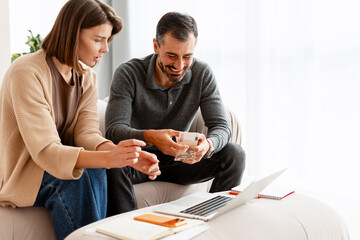 Couple managing finances counting euro cash at home