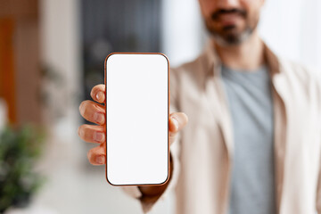 Hand holding smartphone with blank screen for mockup