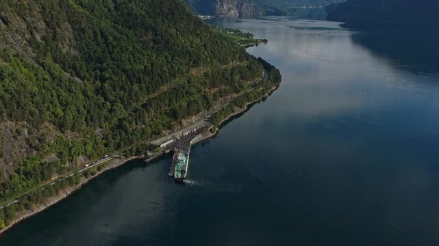 Ro-ro ferry sails through Storfjord with mountains rising behind, Norway