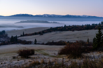 Rural landscape with mountain views at sunrise.