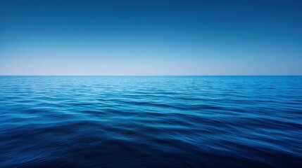 Obraz premium Serene Blue Ocean View Under Clear Sky with Gentle Waves and Calm Water Surface Offering a Sense of Peace and Tranquility in Nature's Embrace