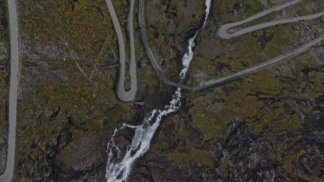 Winding road of Trollstigen with cars climbing steep mountain curves
