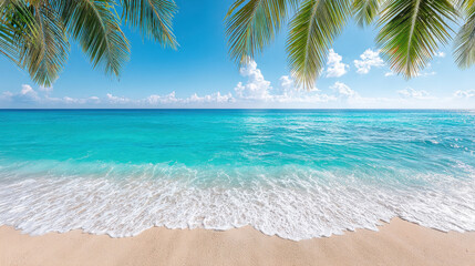 Tropical beach with turquoise ocean water, white sand shore, and palm tree leaves under bright blue sky with clouds