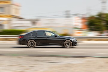 Car driving on road at high speed with  moving background.