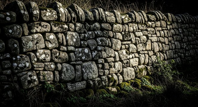 Ancient dry stone wall with moss and lichen textures evoking rustic charm and natural beauty in the countryside landscape photography - Powered by Adobe