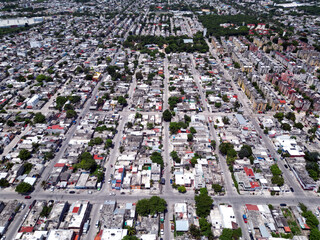 Aerial top-down view high altitude of slum a heavily populated urban informal settlement characterized by substandard housing and squalor poor living conditions streets and rusty metal home roof tops