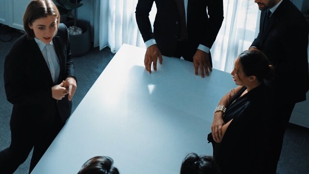 Top view of project manager looking at meeting table surrounded by diverse business people brainstorm and planning strategy. Group of smart people discussing and solve business problems. Directorate. - Powered by Adobe