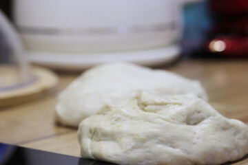 Two lumps of dough before rolling out on the table, preparation for the national Georgian dish khachapuri, close-up