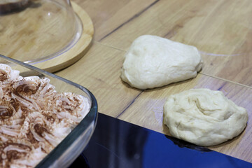 Two lumps of dough before rolling out on the table, preparation for the national Georgian dish khachapuri