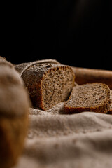 Homemade sourdough rye and wheat bread in warm brown and beige tones. Rustic still life with natural light and organic texture, symbol of traditional baking and wholesome food.