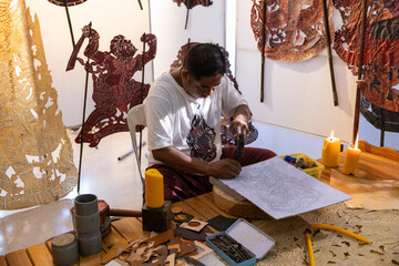 Craftsmen create traditional Thai Khon puppets.