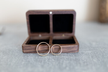 obrączki ślubne przed drewnianym etui