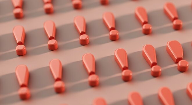 Close-up of multiple orange push pins arranged in neat rows on a flat surface