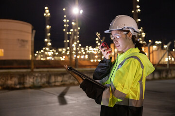 Engineers Conducting Night Inspection at Refinery