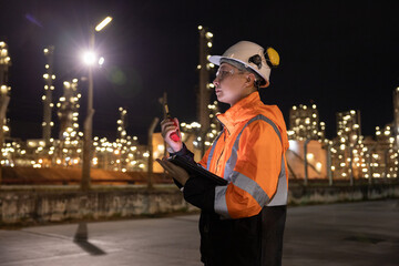 Engineers Conducting Night Inspection at Refinery