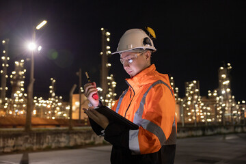 Engineers Conducting Night Inspection at Refinery