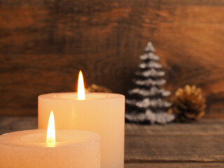 Second Advent candles burning with Christmas decoration on wooden background