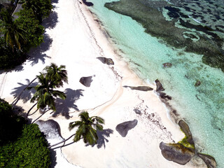 Anse Cocs beach, La Digue Seychelles, tropical beach during a luxury vacation in Seychelles. Tropical beach Anse Cocs beach, La Digue, Praslin, Mahe Seychelles with turqouse colored ocean