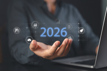 Hand holding holographic 2026 with strategy analytics cloud startup icons for business planning and digital transformation