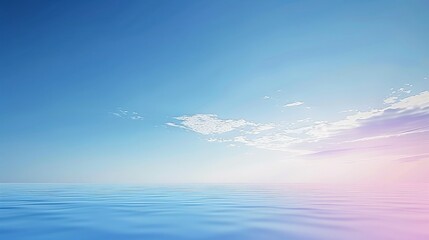 Serene seascape view of calm ocean water meeting pastel sky with soft clouds at horizon line