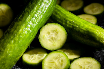 sliced cucumber on black background