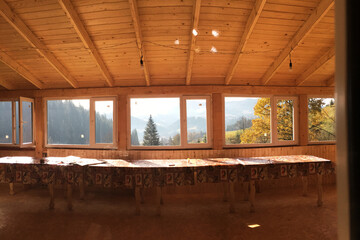 Beautiful amazing natural landscape in the mountains of Ukraine. Travel the world, discover wild locations. Protect the environment movement. Mountain view through the wooden window of ethnic house.