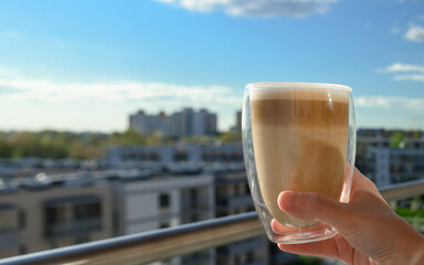 a cup of hot cappuccino in a restaurant with a view of the city, a city break