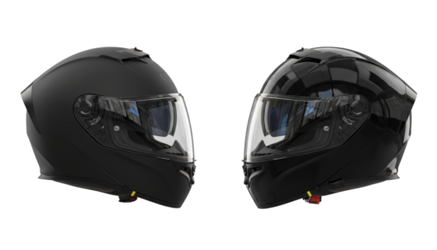 Two matte and glossy black motorcycle helmets facing each other