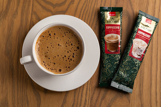 Overhead View of Hot Cappuccino Cup and Jacobs Instant Sachets