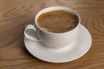 Close Up White Cup of Hot Cappuccino on Wooden Table