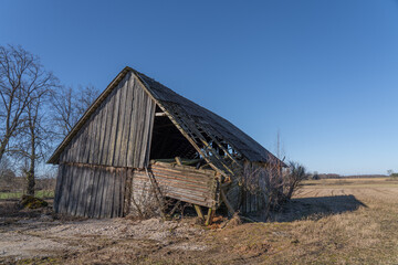 Old crooked barn in the field