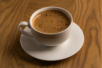Close Up White Cup of Hot Cappuccino on Wooden Table