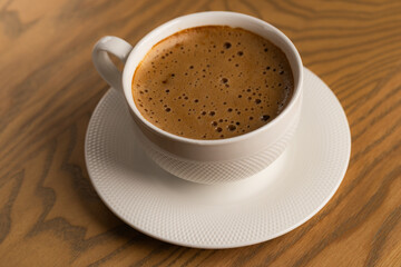 Close Up White Cup of Hot Cappuccino on Wooden Table