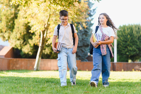 School children walking with backpacks and books