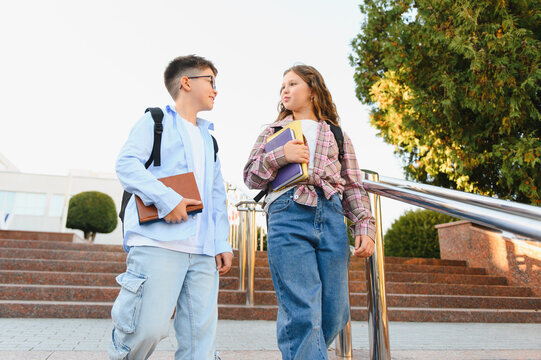 Schoolchildren walking and talking on campus stairs - Powered by Adobe