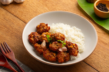 Fototapeta premium Fried Pork Balls(minced pork) with Garlic and Pepper and cooked rice in white plate.