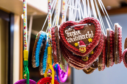 Close up of hanging gingerbread hearts with festive German greeting  “Frohe Weihnachten” (Merry Christmas)