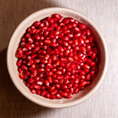 vibrant close-up of fresh pomegranate arils showcasing their rich red color and glossy texture. Perfect for illustrating concepts of health, nutrition, organic food, and freshness
