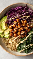 Healthy Quinoa Bowl with Roasted Chickpeas Avocado and Red Cabbage.