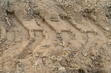 Background from a part of a truck tire print on a dirt road