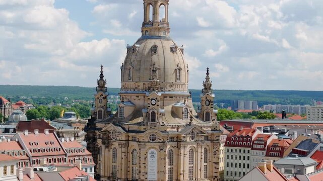 The drone captures Dresden&rsquo;s Frauenkirche from above, showcasing its baroque architecture and the surrounding old town under clear summer skies.