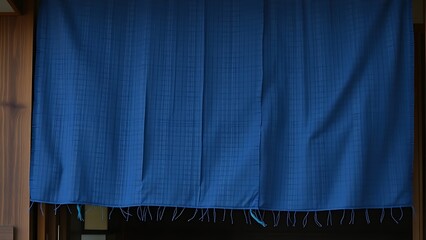 noren. A traditional indigo-dyed fabric noren at an entrance, textile texture with natural folds. event programs, museum guides, designed for cultural heritage projects and event programs.